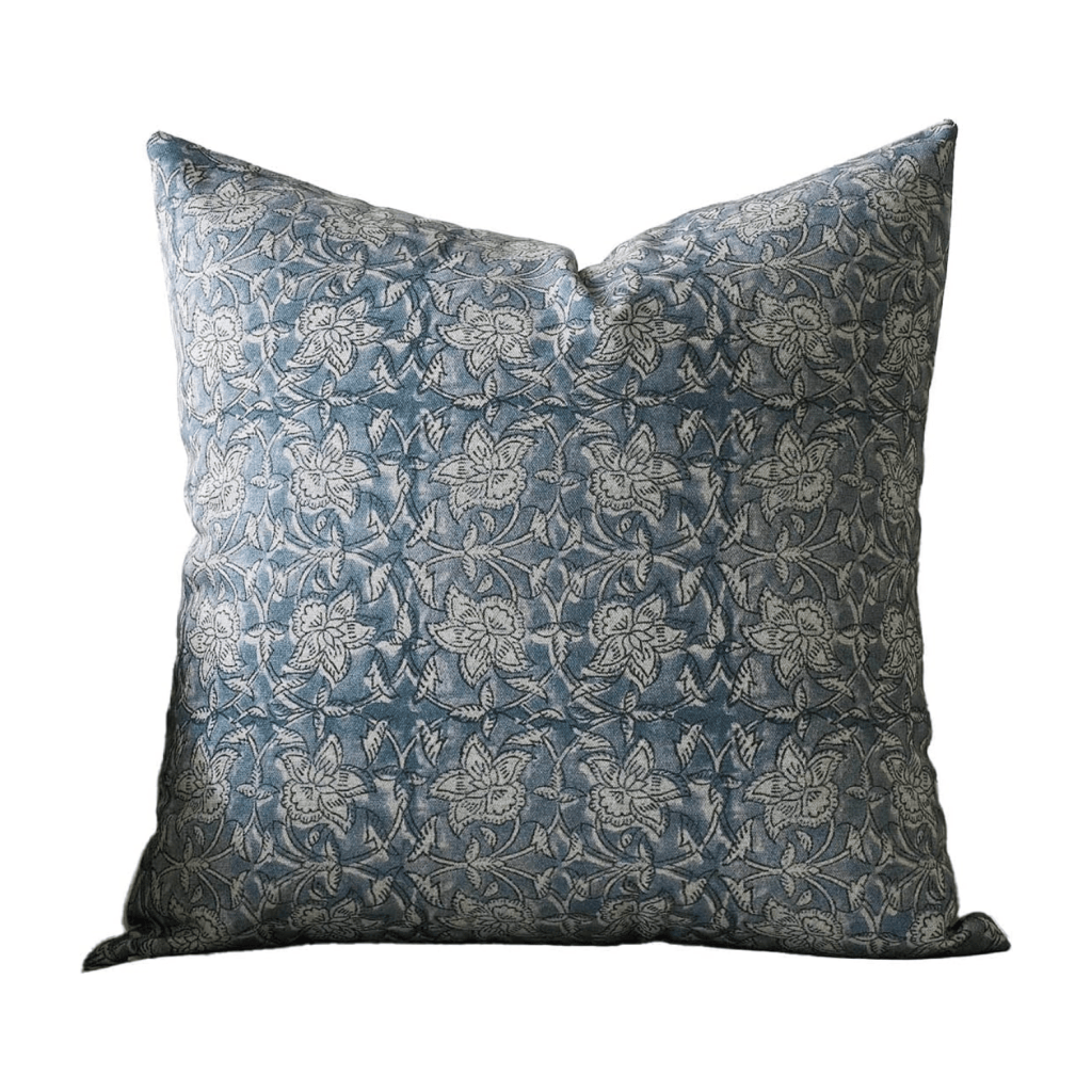 Decorative pillow with a blue fabric featuring a floral pattern in light gray.
