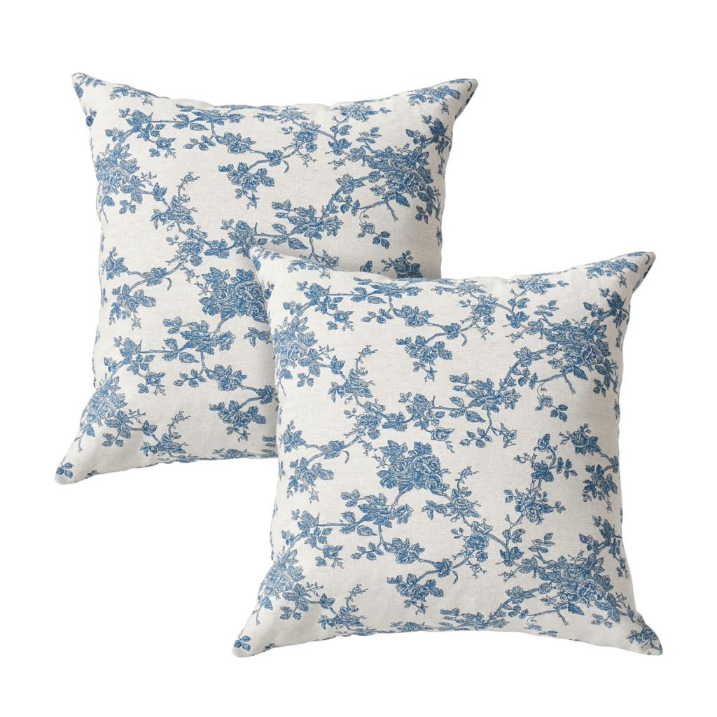 Two decorative pillows with a blue floral pattern on a light background.