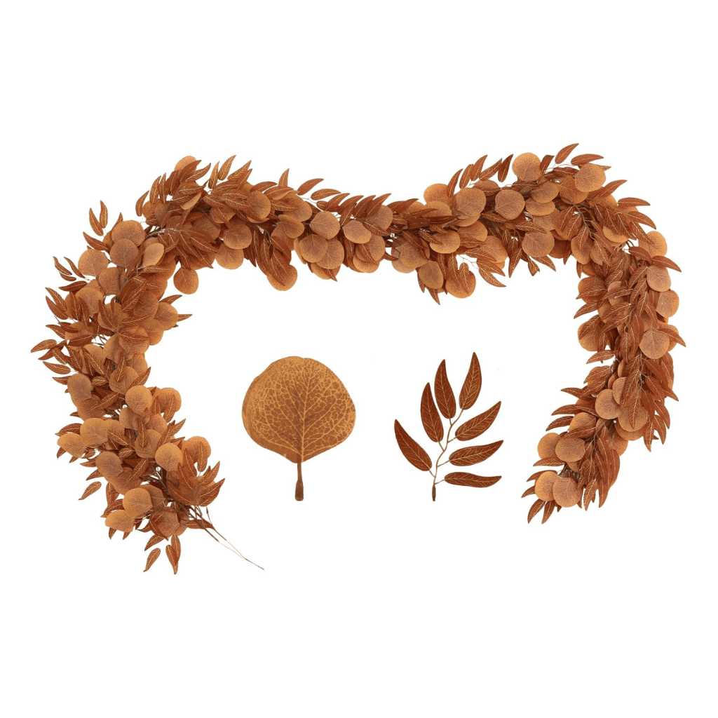A decorative arrangement of dried brown leaves forming a wreath, accompanied by separate individual leaves and branches on a white background.